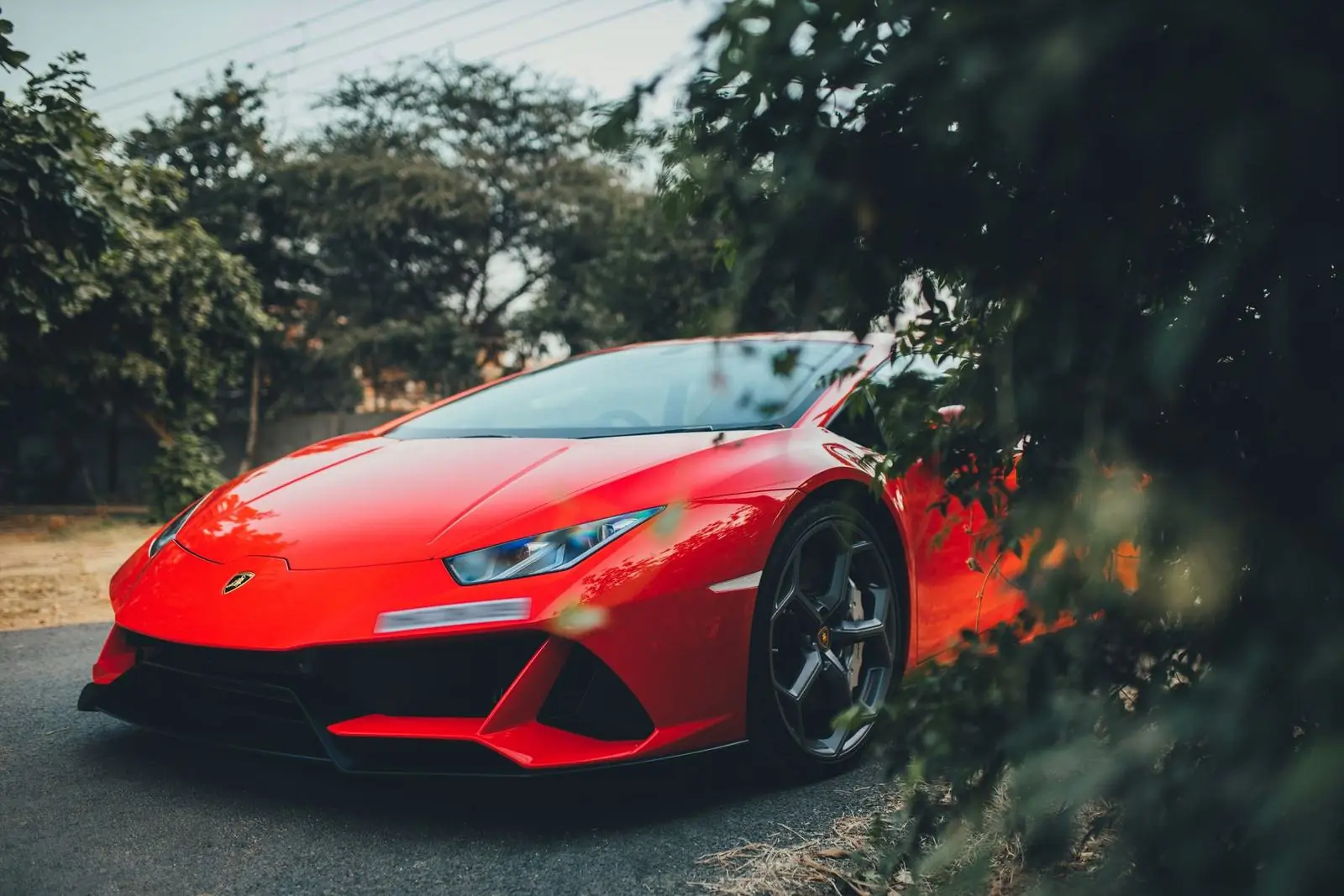 Red Lamborghini Huracán EVO among trees