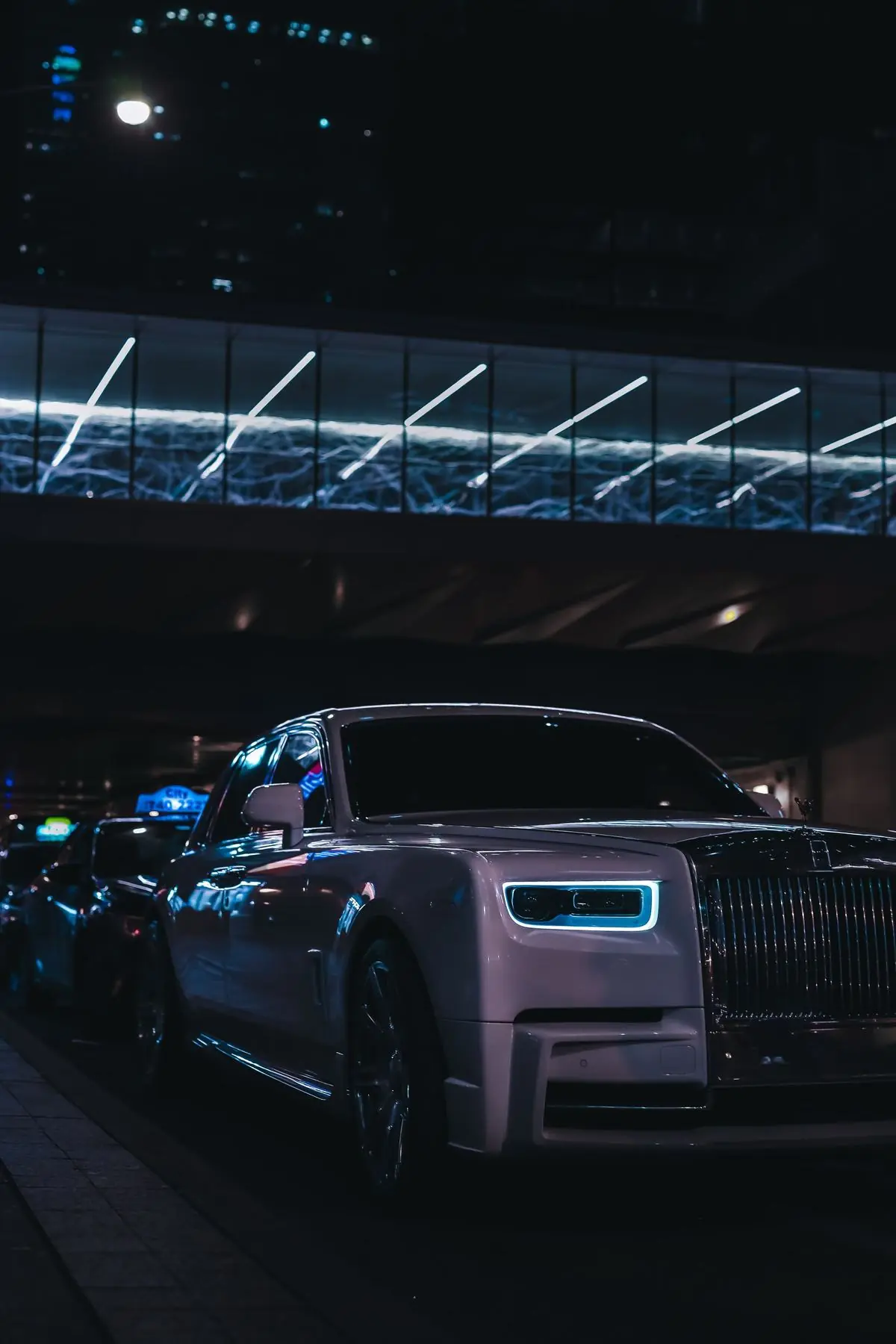 Rolls-Royce Phantom under city lights at night