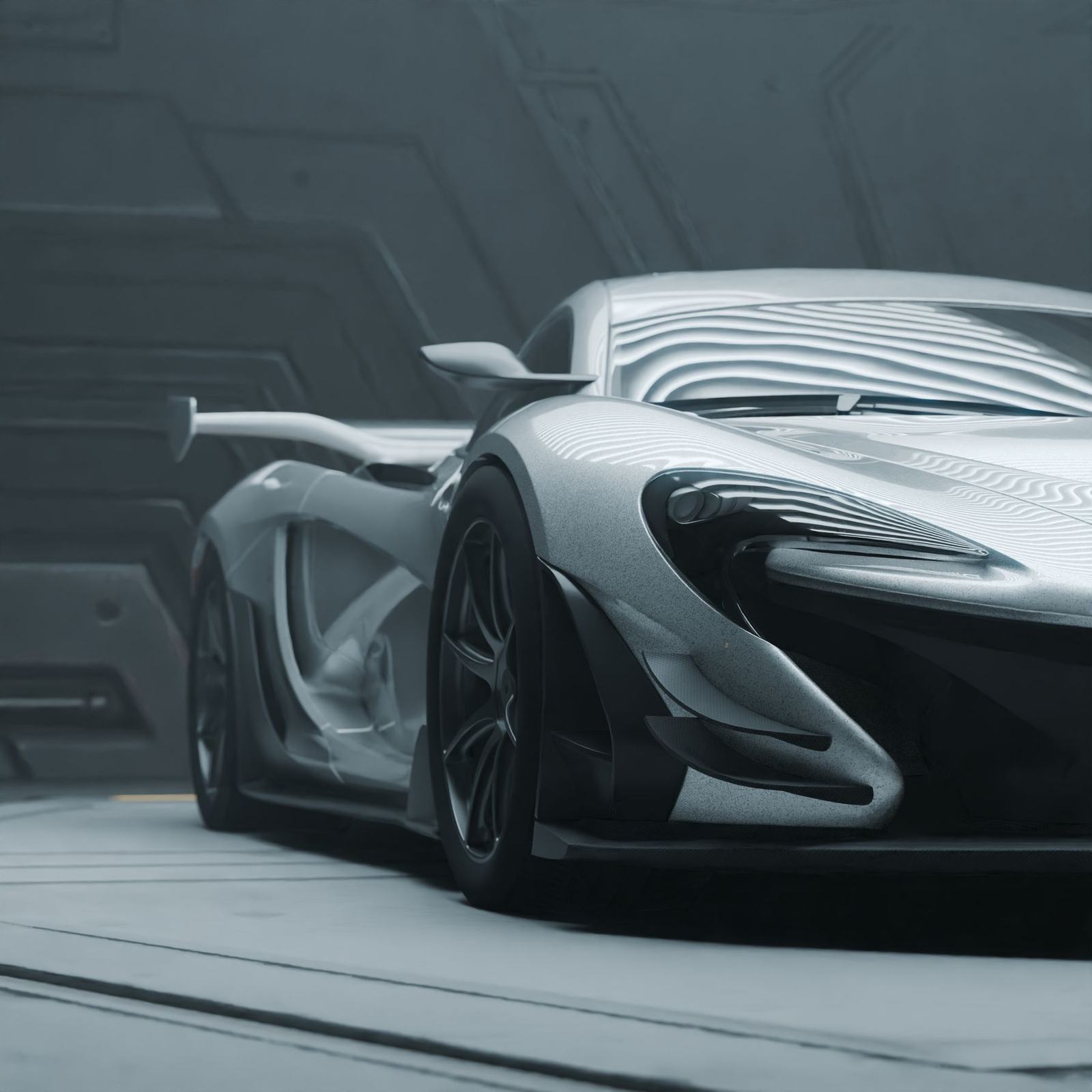 Silver McLaren P1 in a high-tech garage