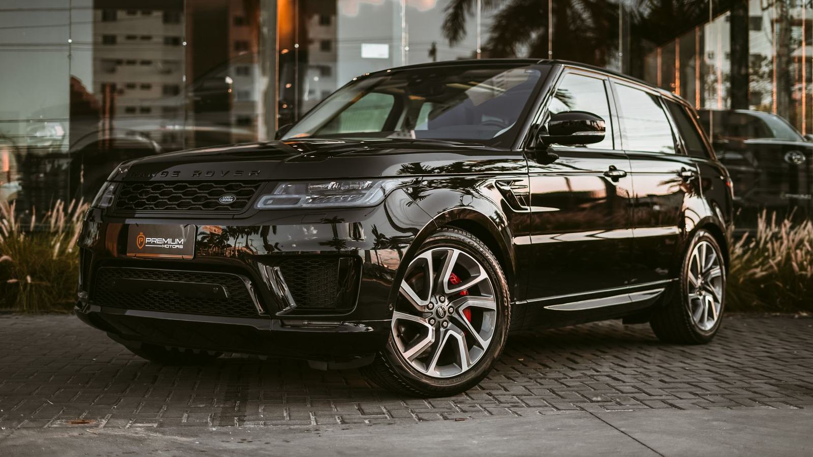 Black Range Rover Sport on stone paving