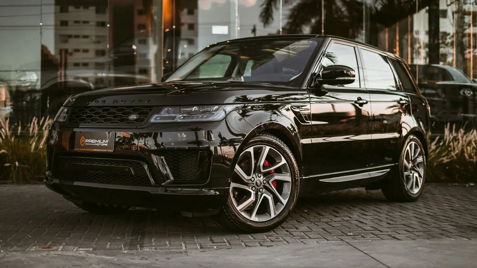 Black Range Rover Sport on stone paving